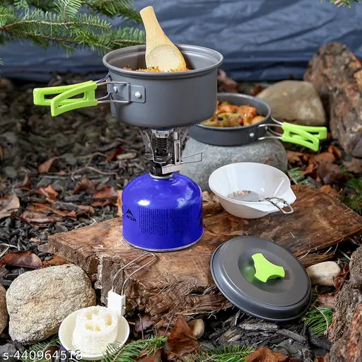 camp stove setup Compact two-burner camp stove setup on a foldable table beside a camper van in a forest.